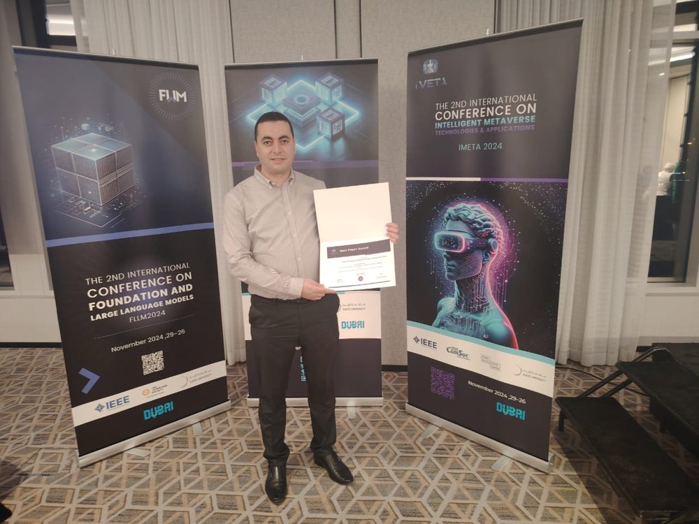 Dr. Bouziane Brik holding the Best Paper Award certificate at iMETA 2024 in Dubai